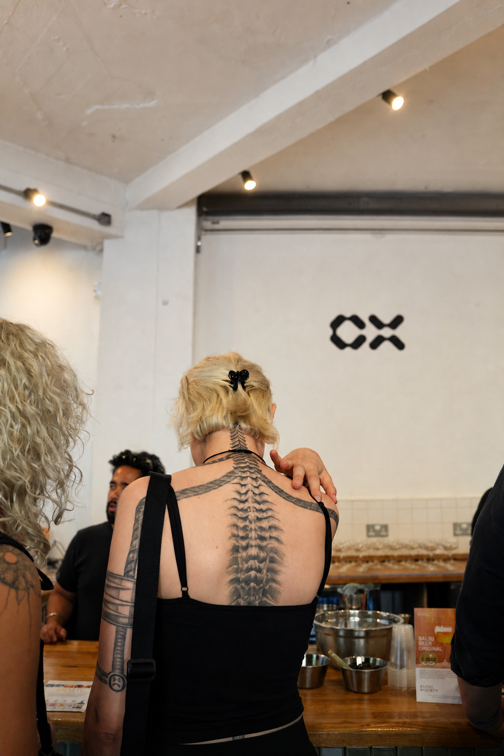 Guest with a full back tattoo inside the CX event space