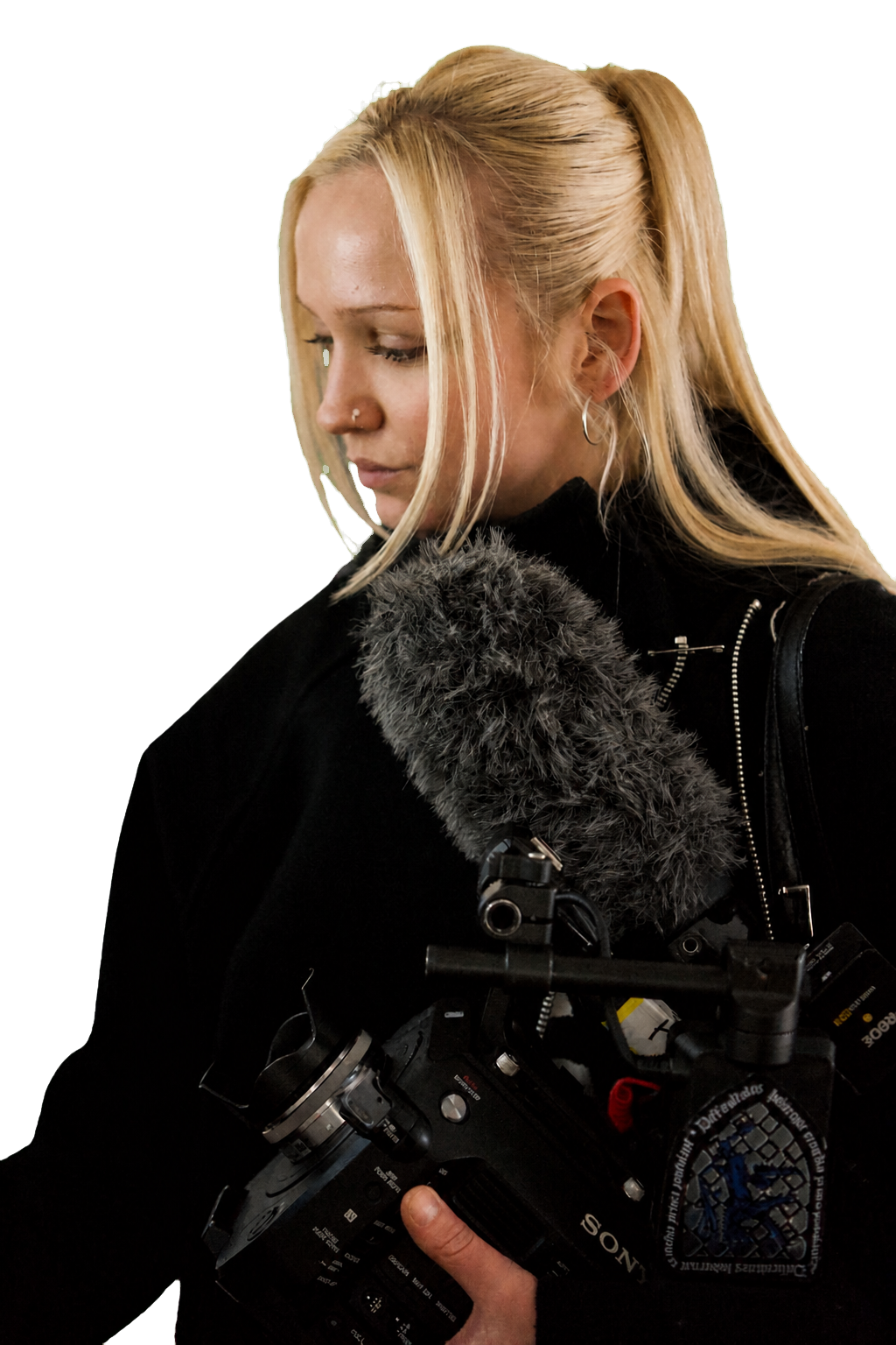 Cutout portrait of Edie holding a camera with an on-camera microphone
