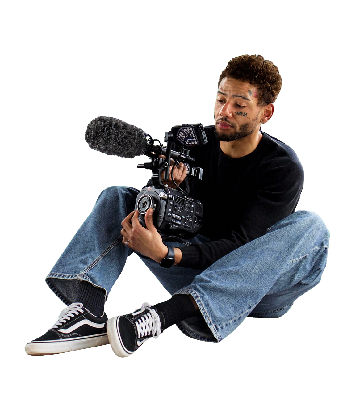 Cutout portrait of Jesse seated with a Sony cinema camera and on-camera microphone